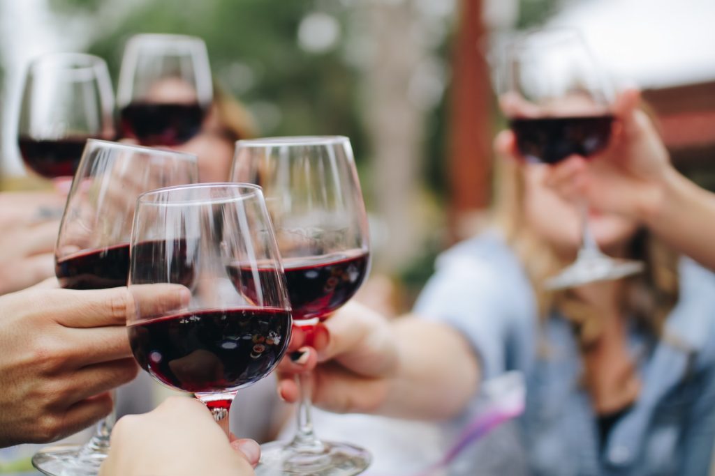 Un groupe de personnes trinquant avec des verres à vin.